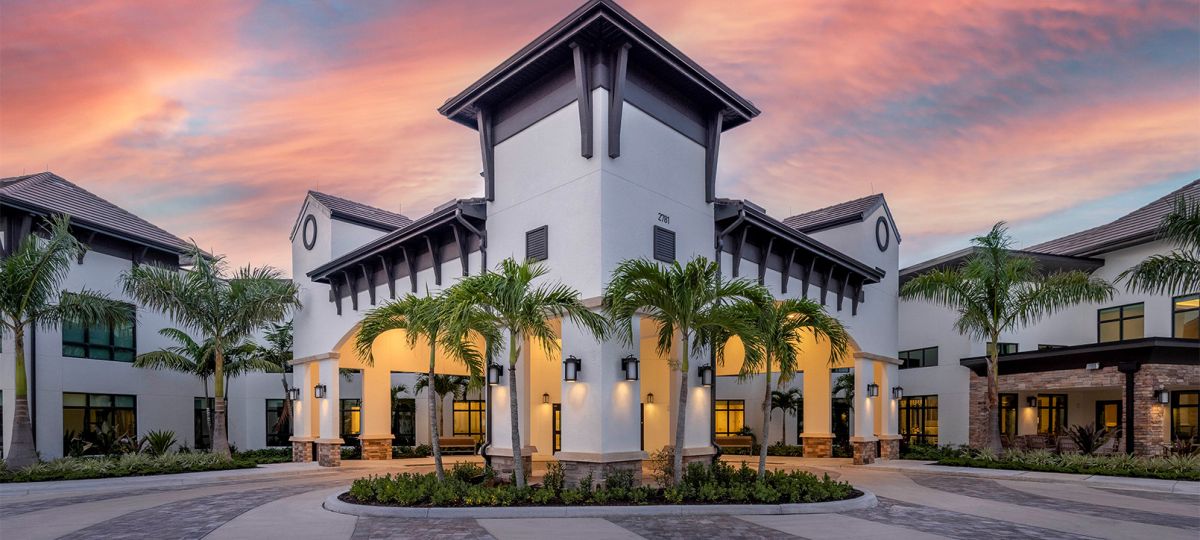 Exterior shot of Siena Lakes community building during sunrise.