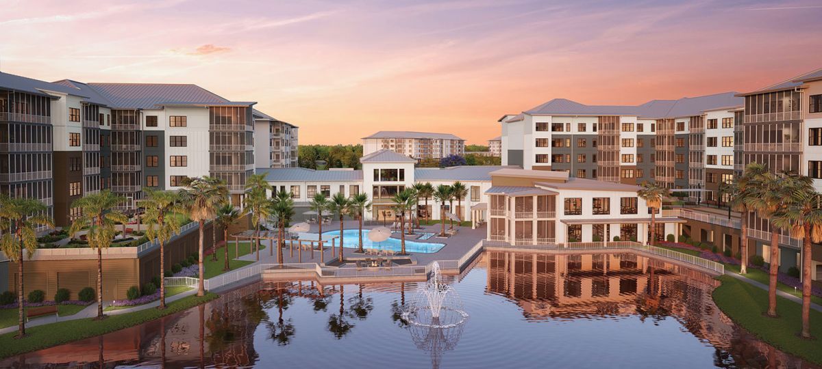 Emerson Lakes, an Erickson Senior Living waterfront community in Sarasota, Florida, featuring palm-lined outdoor pool, fountain, and modern residential buildings at sunset.
