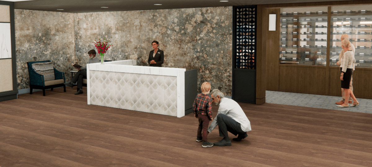 Modern lobby reception desk with staff member assisting, a child with an adult nearby, and a waiting area in the background.