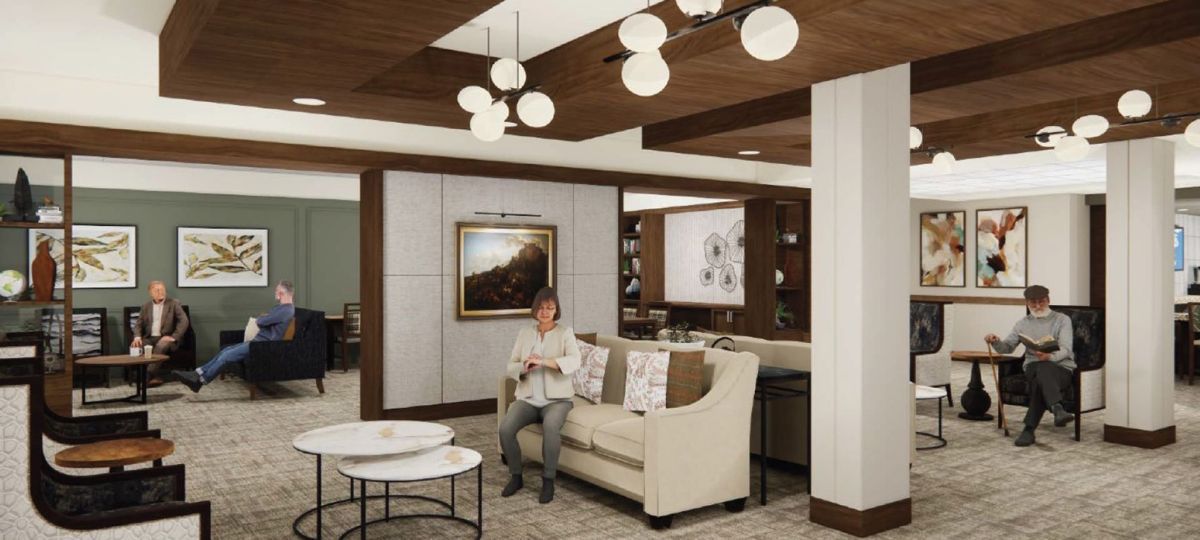 Welcoming senior living lobby with sofas, round coffee tables, wood ceiling beams, and residents gathered in conversation.