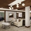 Welcoming senior living lobby with sofas, round coffee tables, wood ceiling beams, and residents gathered in conversation.